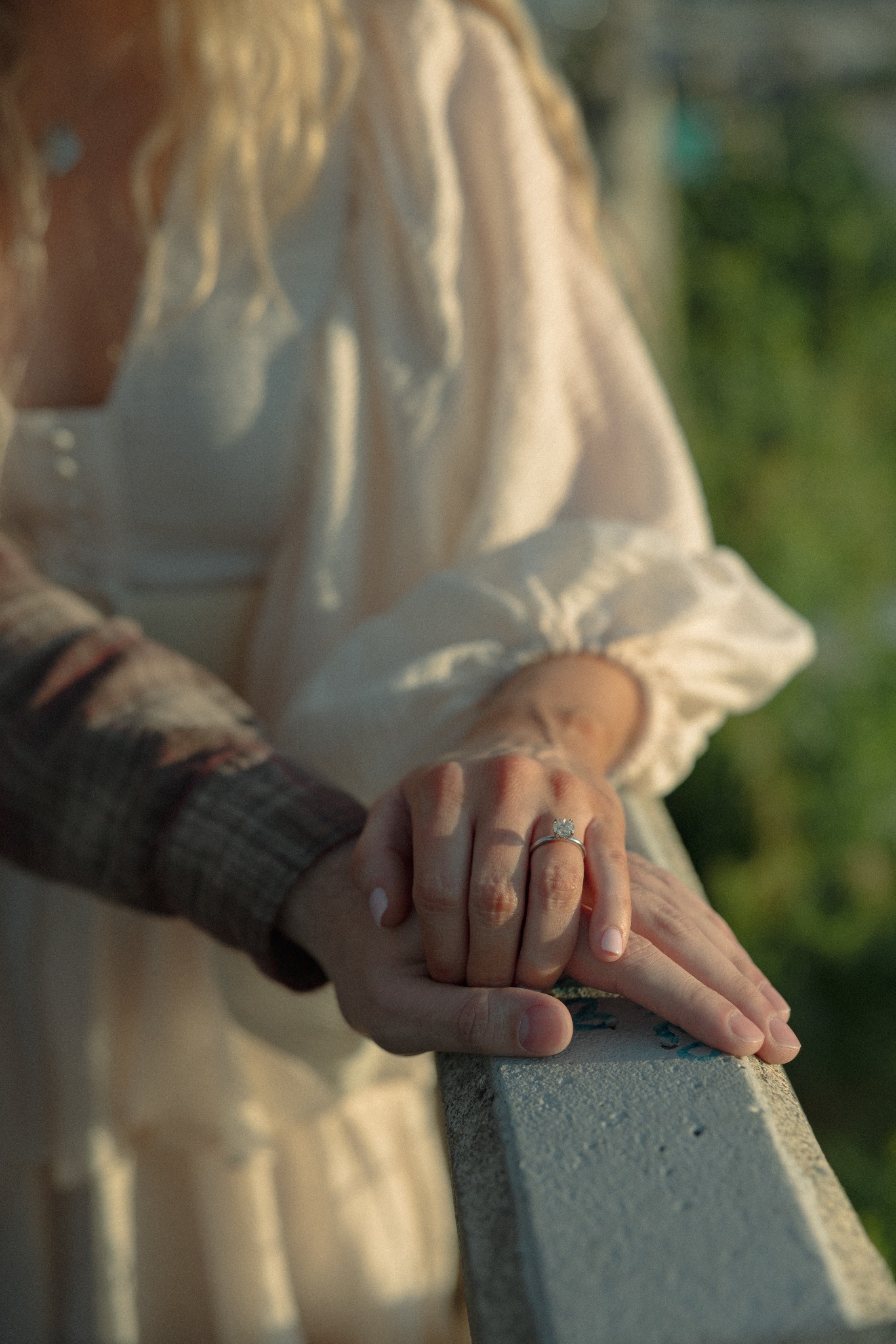 Close-up of Jamie's engagement ring as she and Sean hold hands
